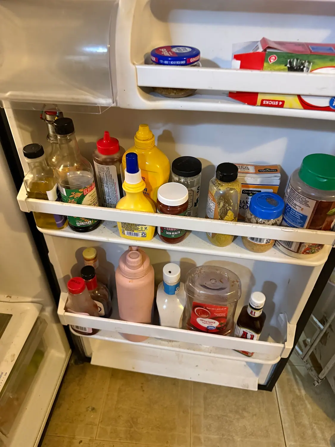 Refrigerator door shelves cleaned and restocked