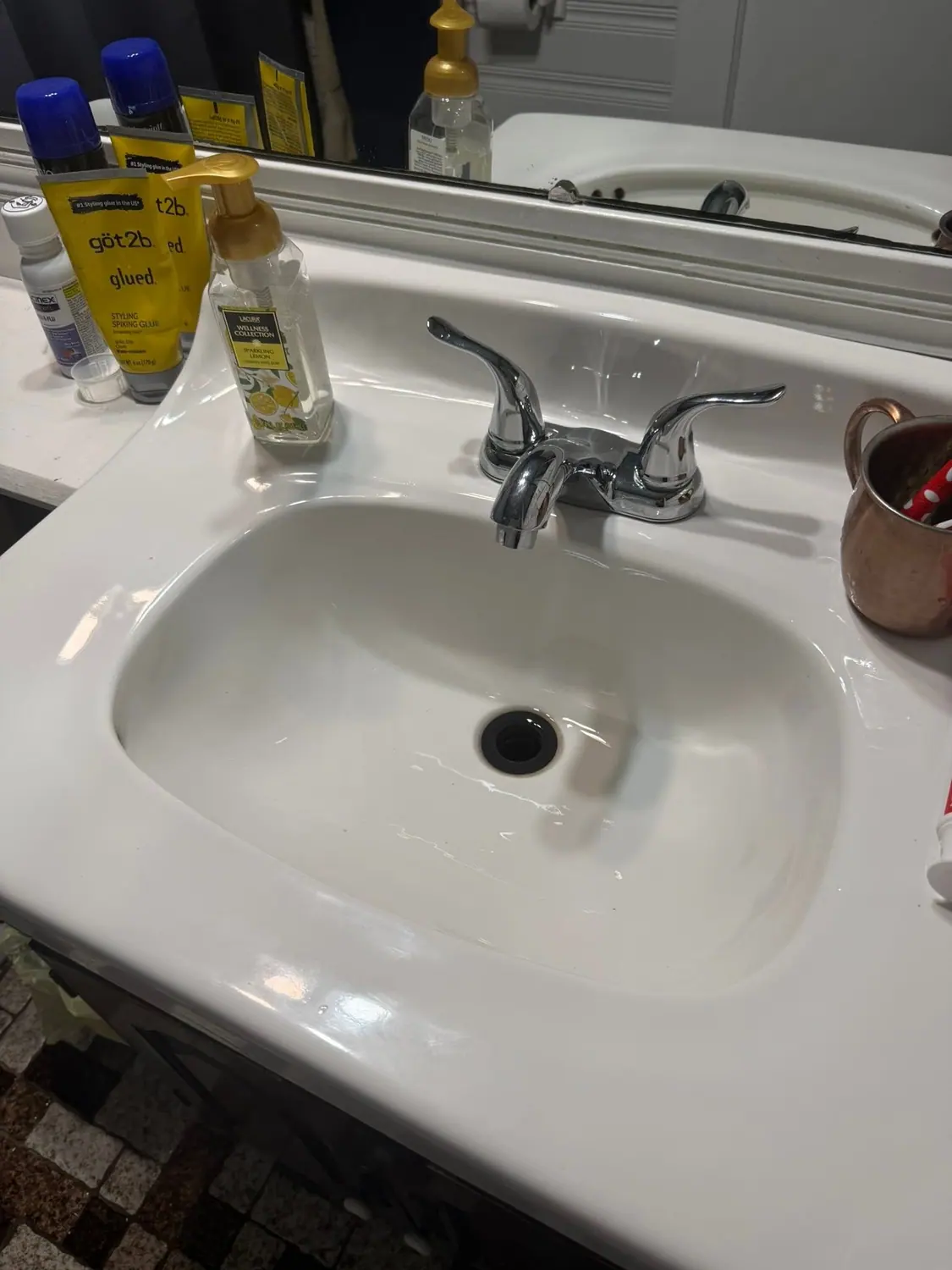Bathroom vanity, mirror, and towel bar left spotless