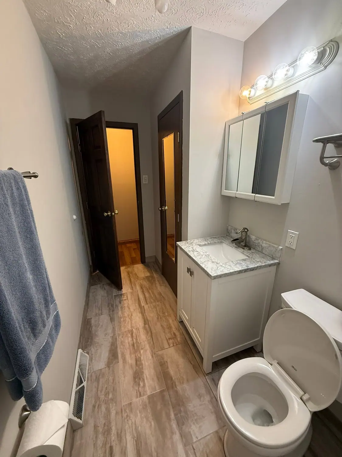 Bathroom vanity, mirror, and towels reset after cleaning