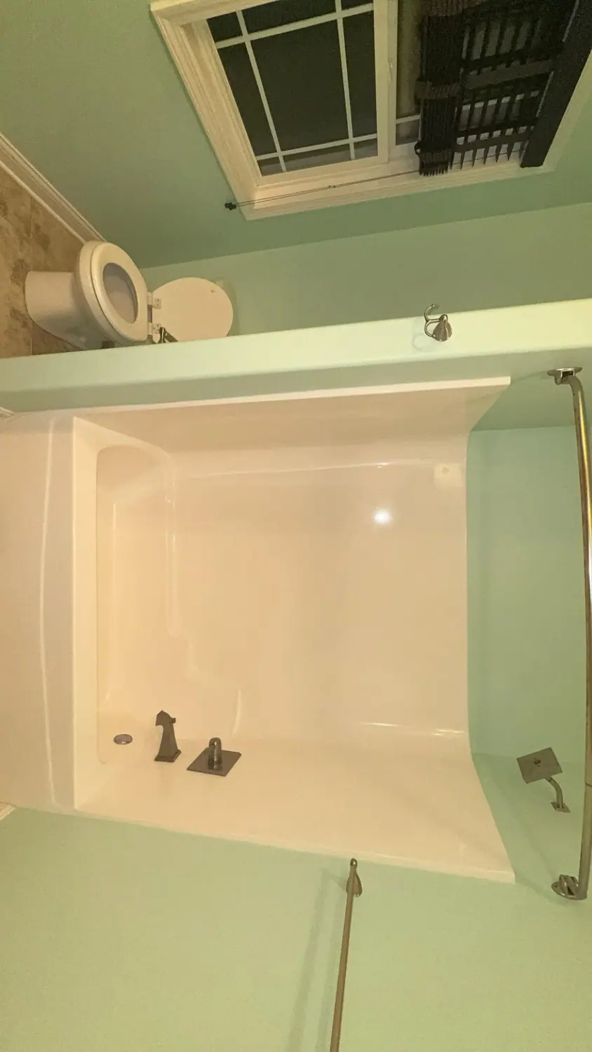 White tub and shower surround scrubbed to a bright finish