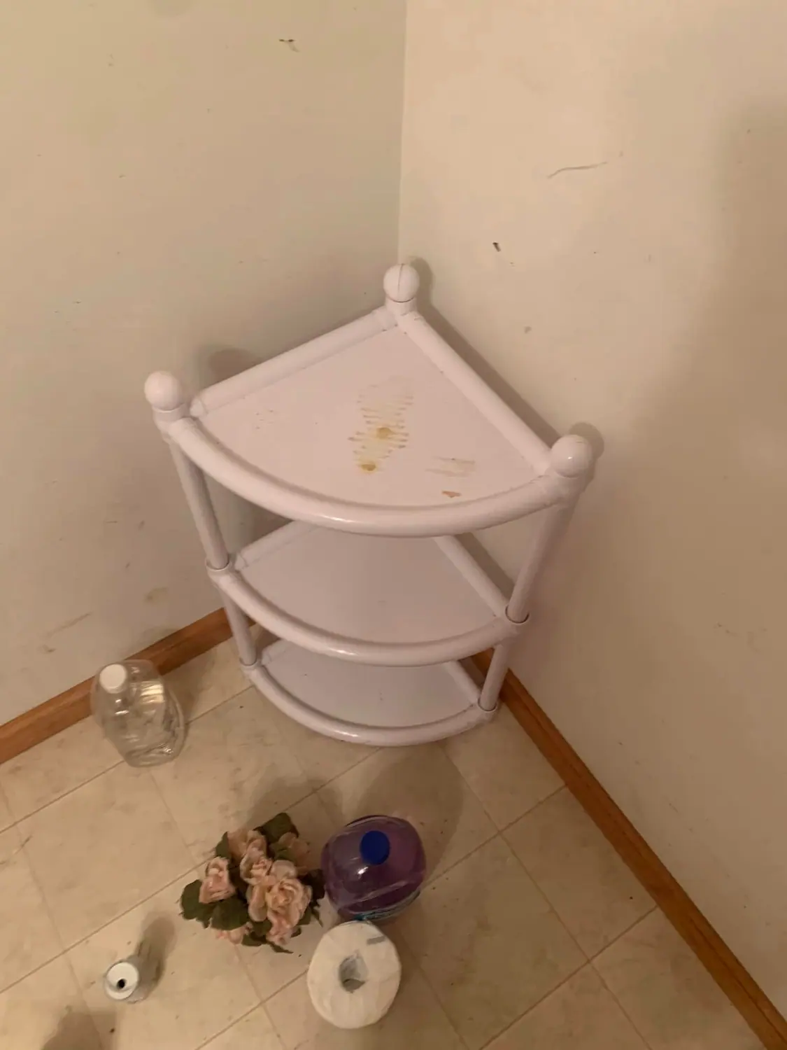 Bathroom corner shelf and tile floor before a deep clean