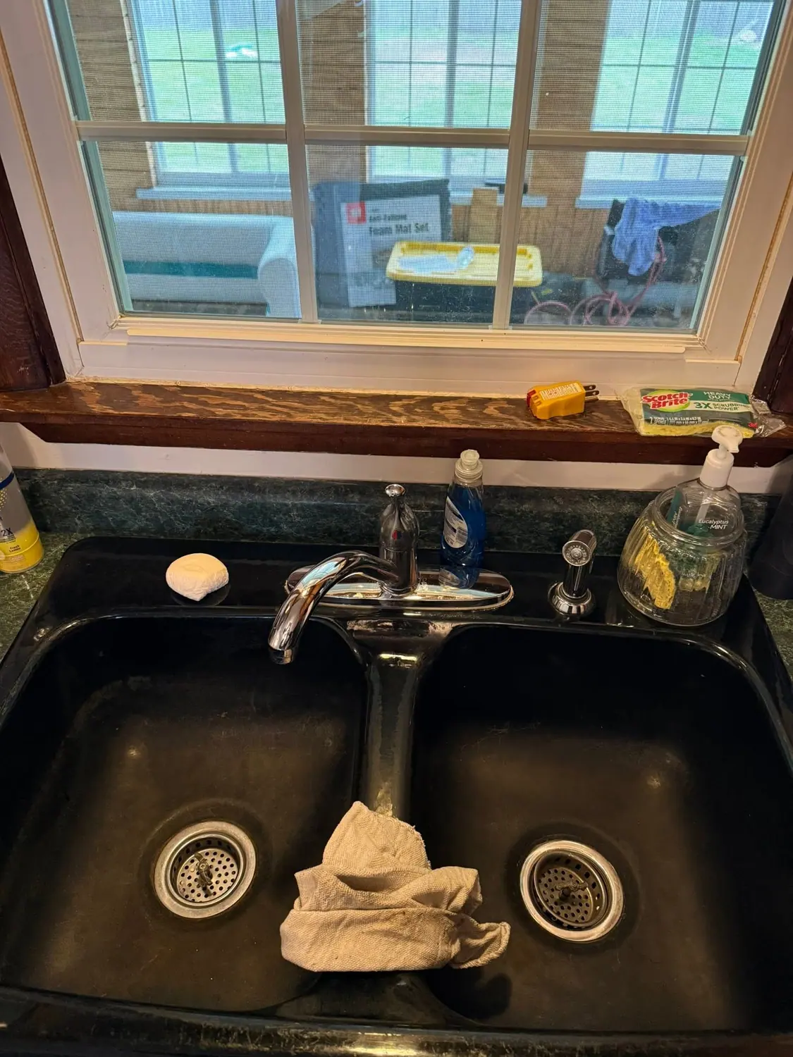 Kitchen sink and window sill before a deep clean