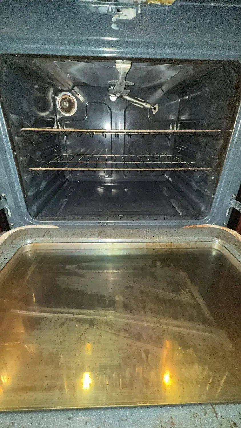 Oven interior coated in baked-on grease before cleaning