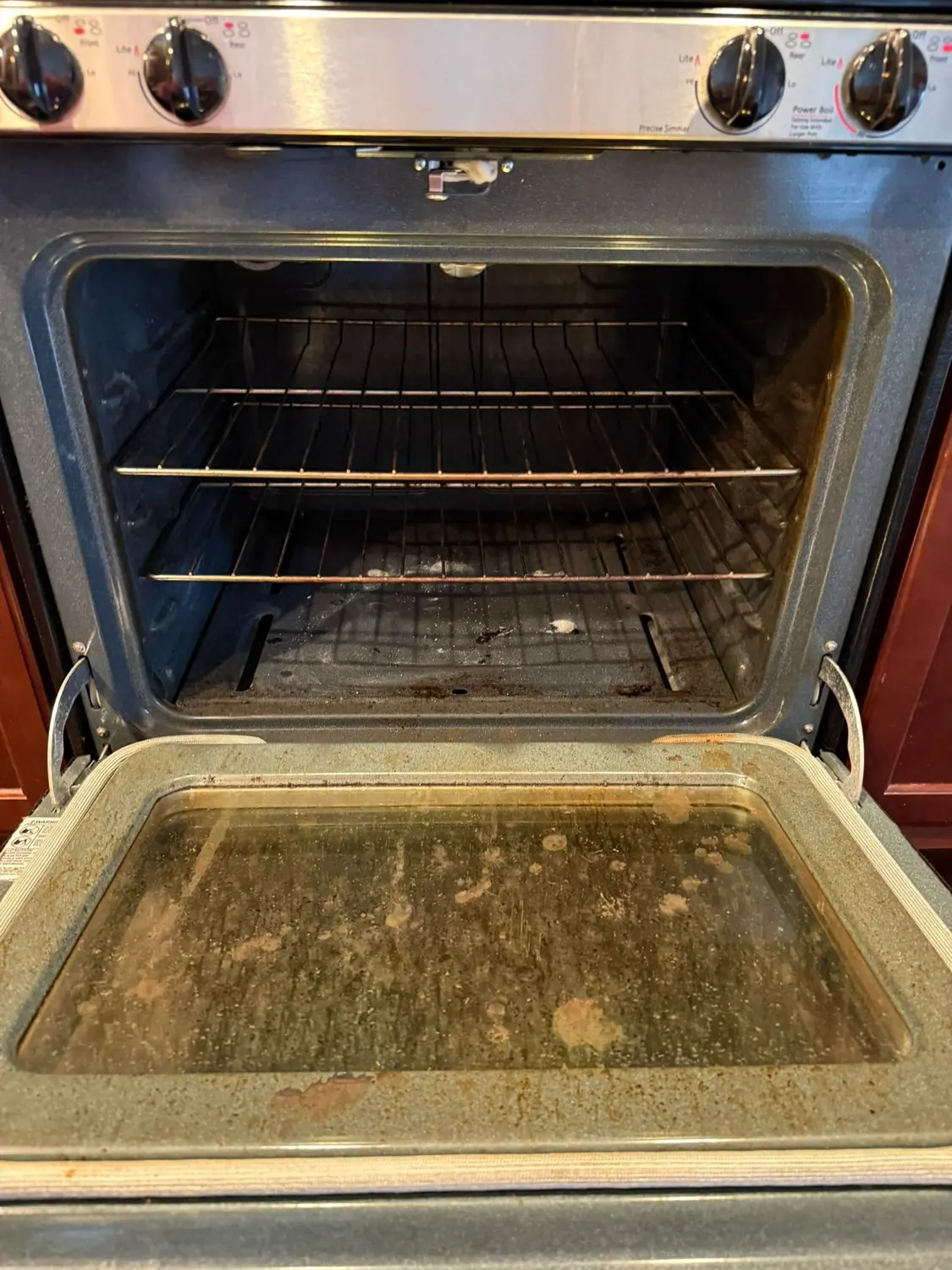 Grease and spills inside an oven before a deep clean