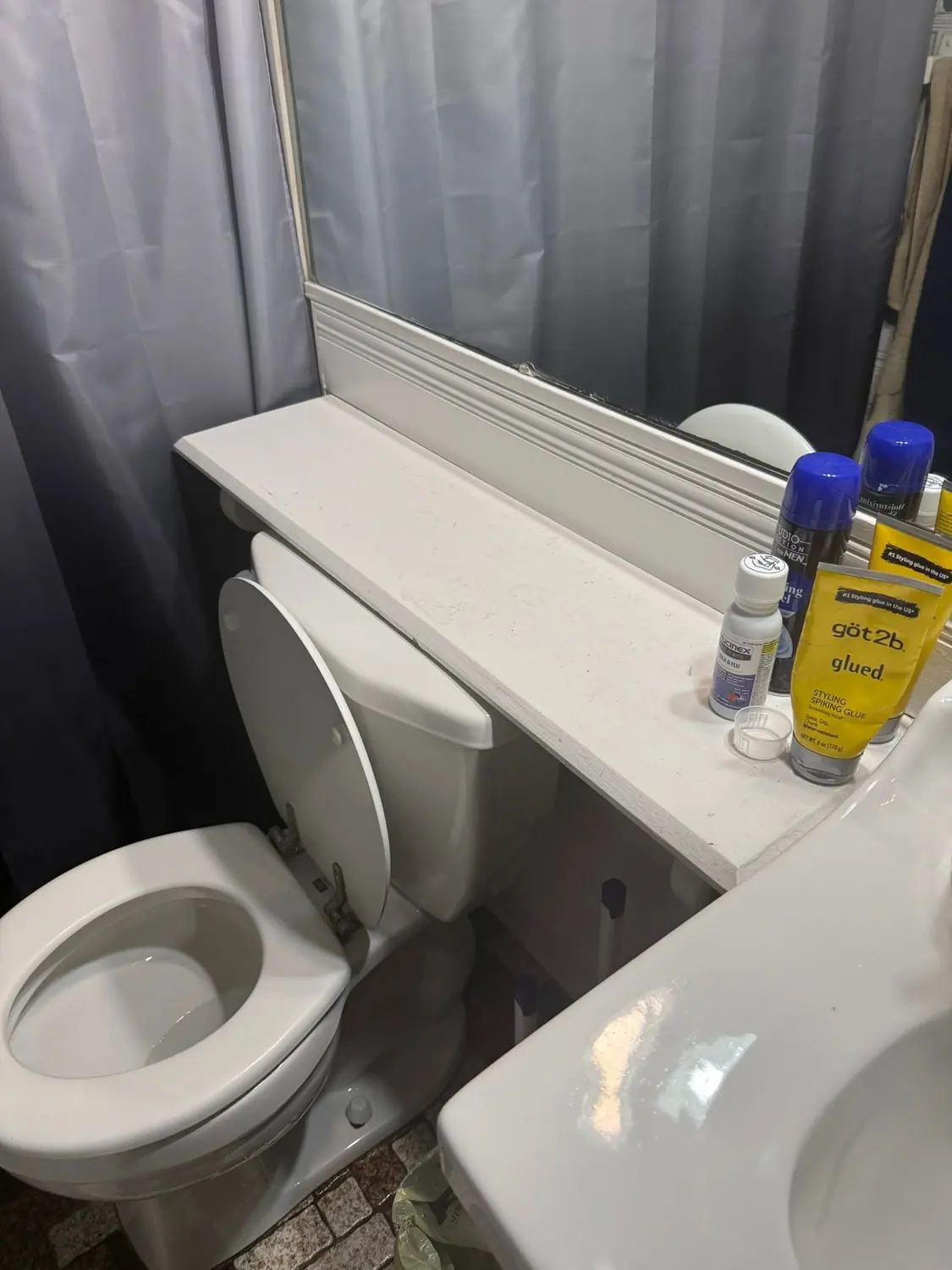 Cleaning products set out on a bathroom shelf during a visit