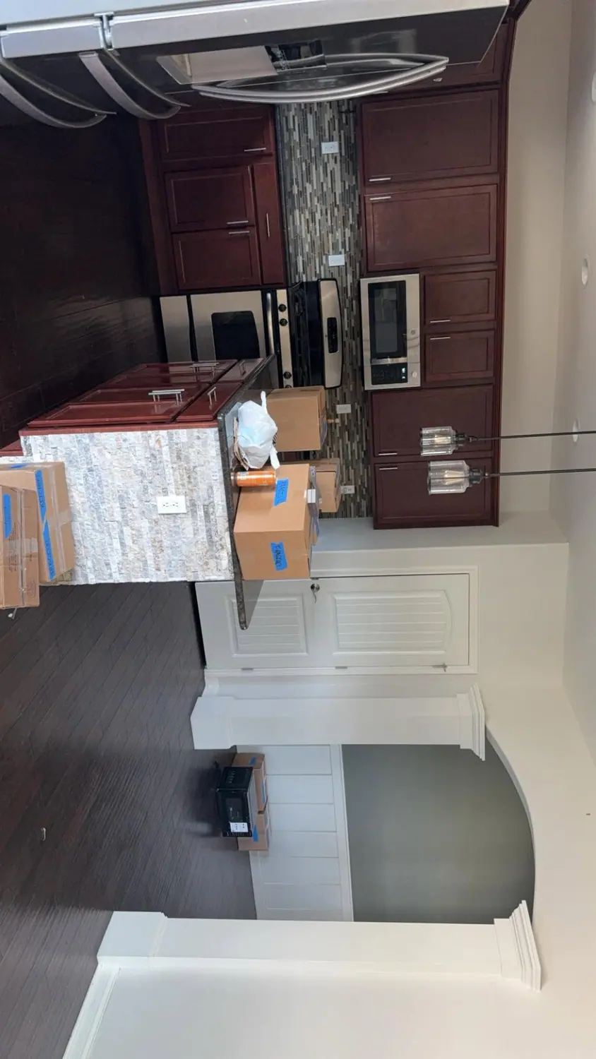 Kitchen island and cabinets wiped during a move-in clean