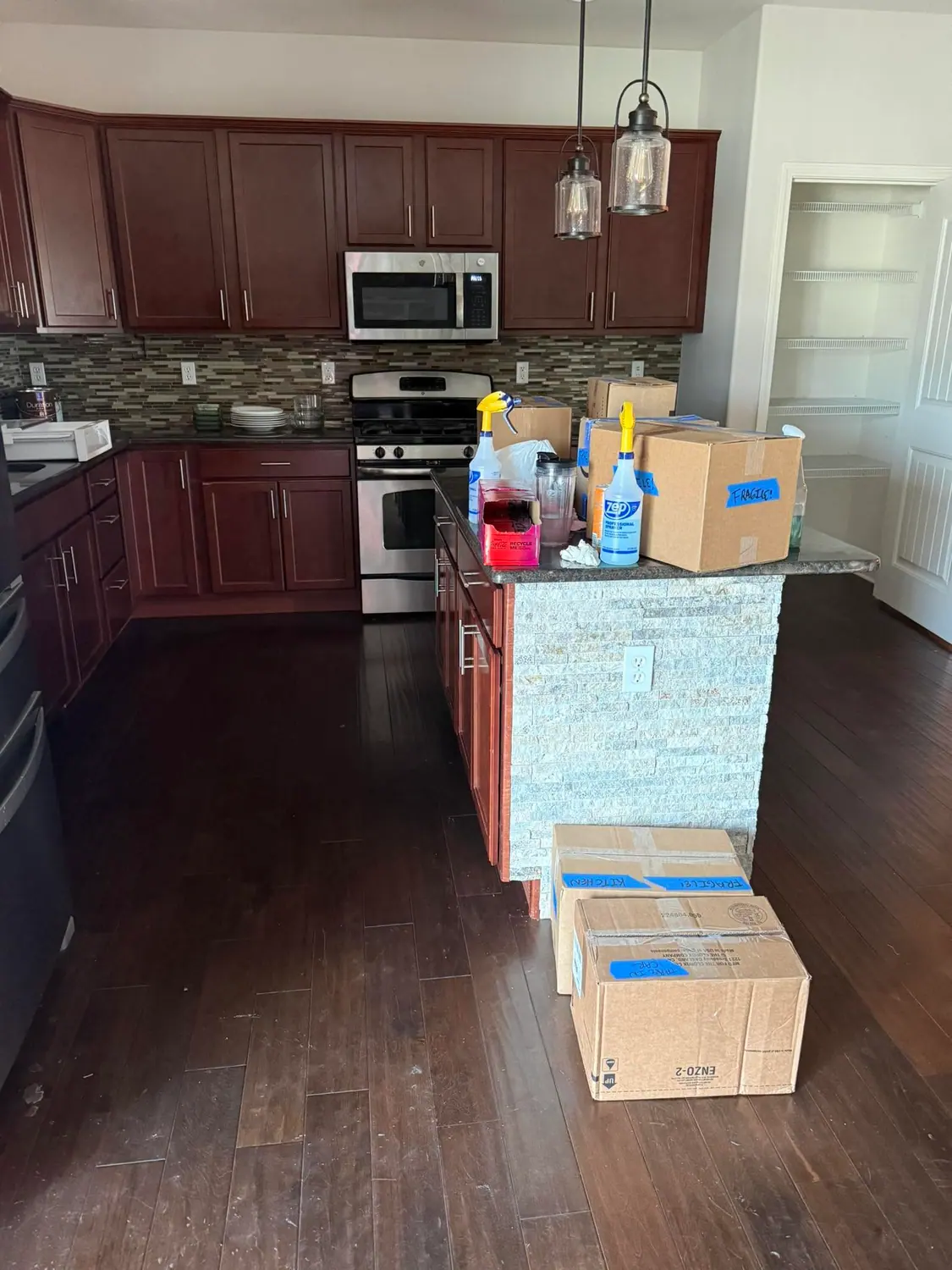 Cleaning supplies staged on a kitchen island at the start of a visit