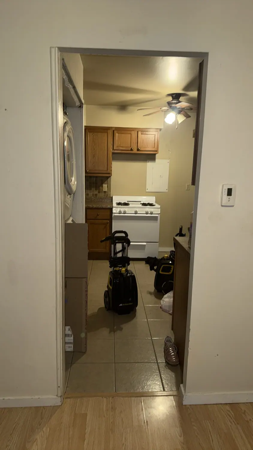Vacuum and cleaning equipment set up in a client kitchen at the start of a visit