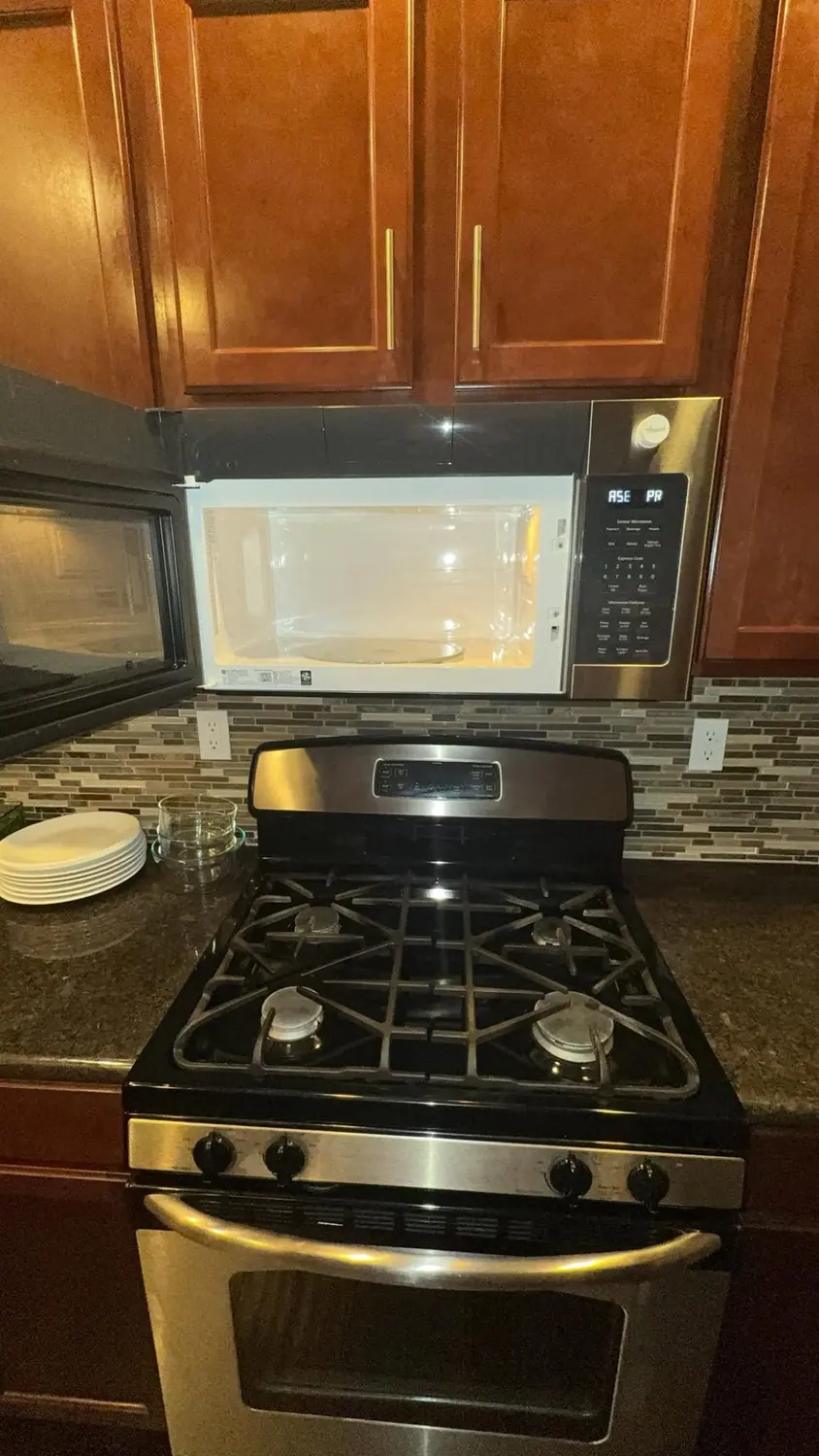 Gas cooktop, microwave, and granite counter degreased