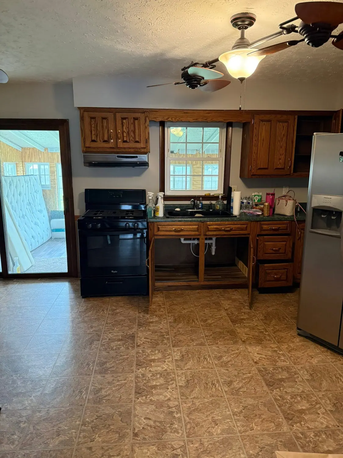 Oak kitchen cabinets, stove, and floor cleaned