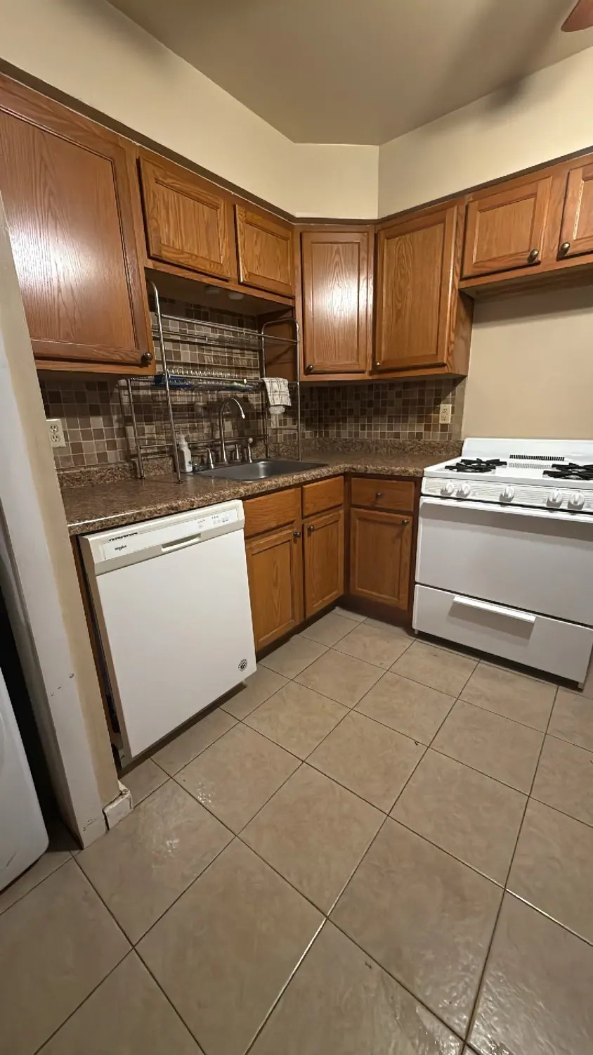 Oak kitchen, stove, and tile floor cleaned
