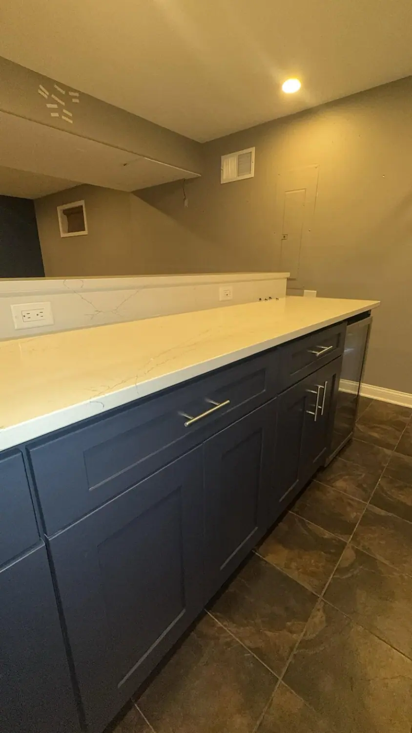 Quartz counter and navy cabinets wiped down end to end