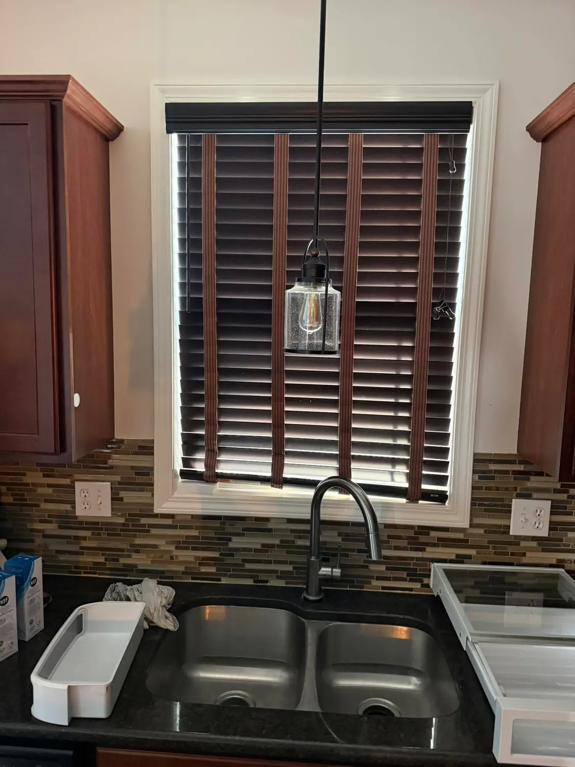 Kitchen sink, faucet, and window sill left spotless