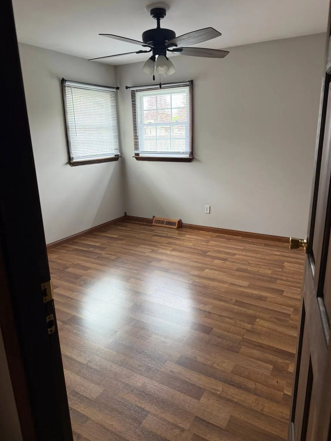 Hardwood floor cleaned in an empty corner room