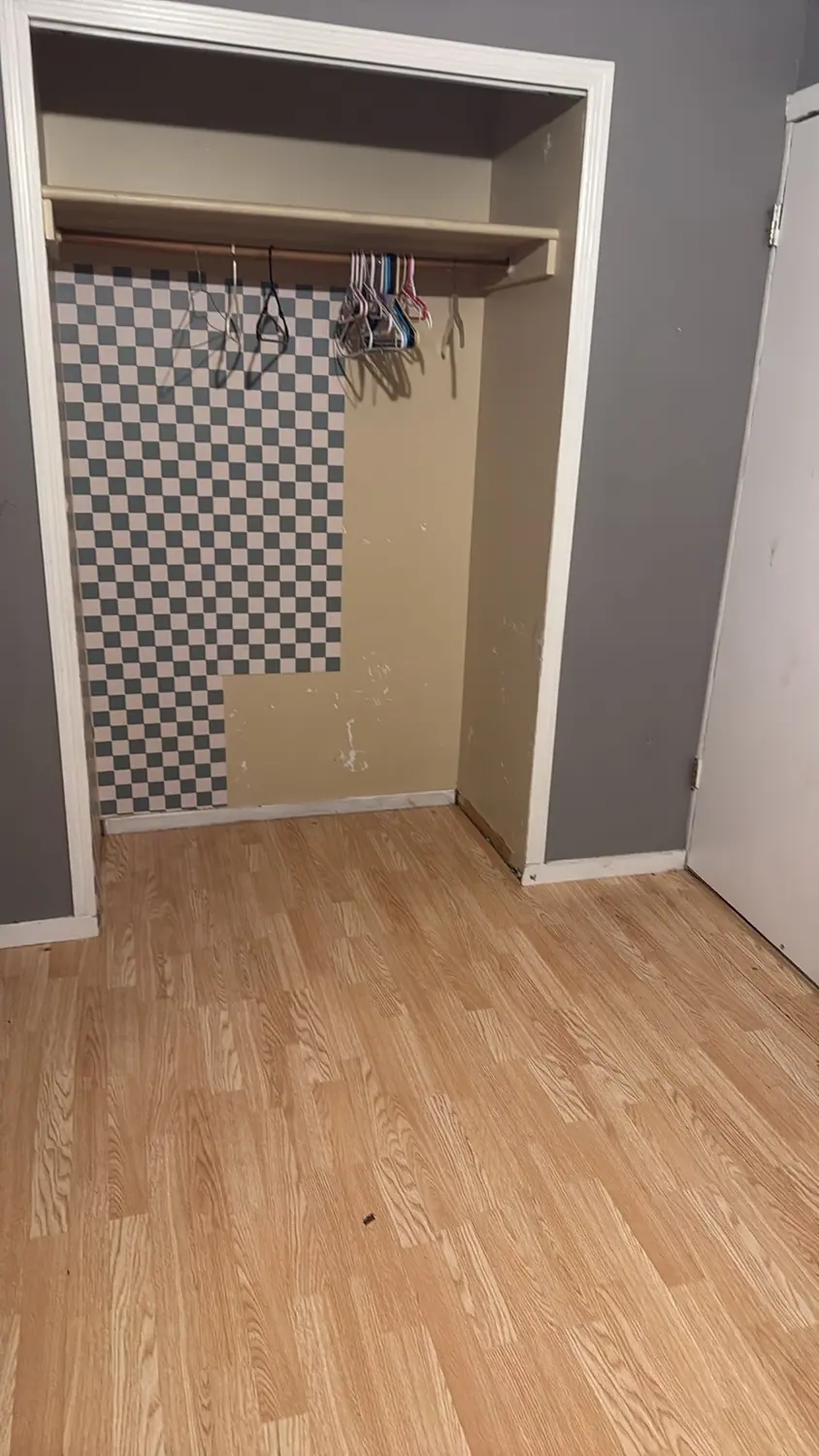 Laminate floor and wall cleaned in a hallway