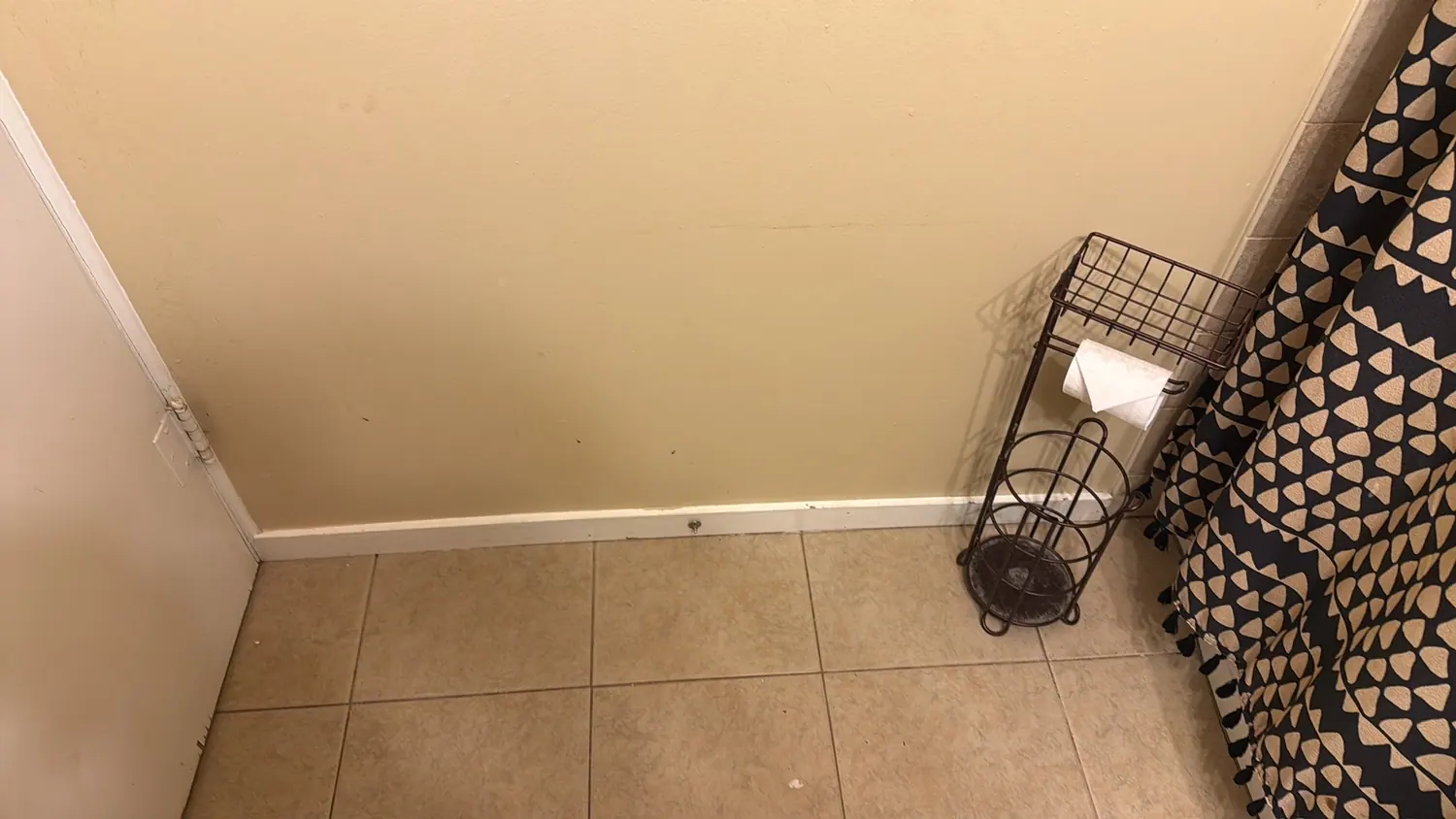 Tile floor and baseboards cleaned along a hallway